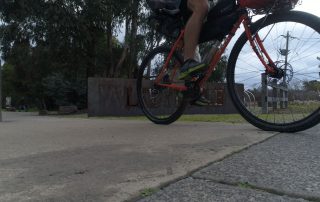 Commuter cyclist on orange bike leaving Lilydale